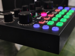 The soundcard is active with multicolored lights, photographed from close range.