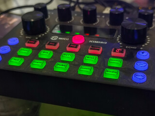 The soundcard is active with multicolored lights, photographed from close range.