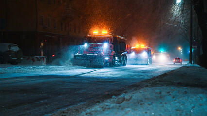 Obraz premium Clearing roads during a winter snowstorm