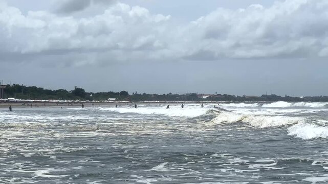 People learning to surf at Legian Beach in Bali