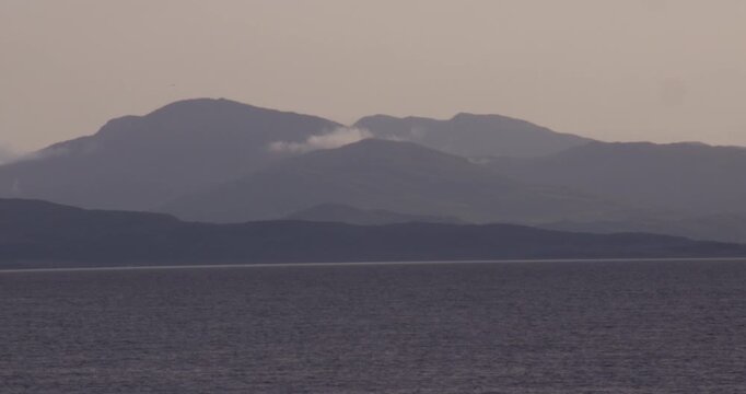 artistic aesthetics wide shot of the Isle of Mull with clouds at duck in the Scottish Highlands