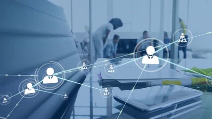Animation of network of connections with icons over diverse business people in office - Powered by Adobe