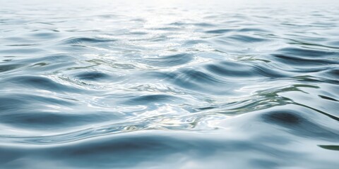 Gentle, undulating surface of clear water reflects bright overhead light