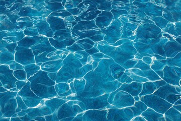 Bright sunlight reflects across the vibrant blue surface of moving water.