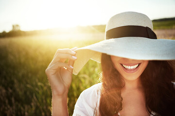 Happy woman, hat and sunset with nature, hide and summer holiday for adventure. Outdoor, cover eyes...