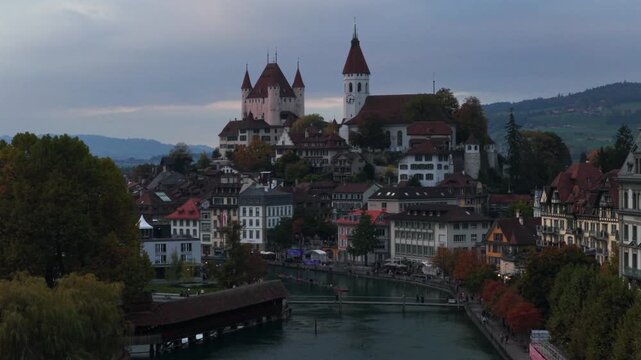 Sunrise Sunset Thun Castle Flusswelle Aare River Schloss Thun Thunersee Switzerland Schweiz Europe Autumn Fall aerial drone morning grey skies pedestrian walkway car Bernese Oberland circle left