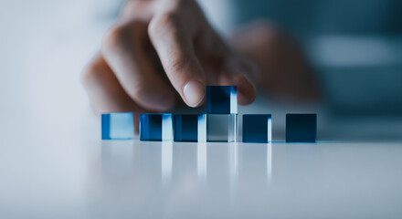 Businesswoman stacking blue transparent cubes on a table, symbolizing growth, strategy, planning, optimization, and abstract futuristic data structure.
