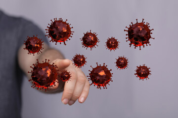 Image depicting the concept of a person interacting with and pointing at 3D rendered virus cells. Illustrative