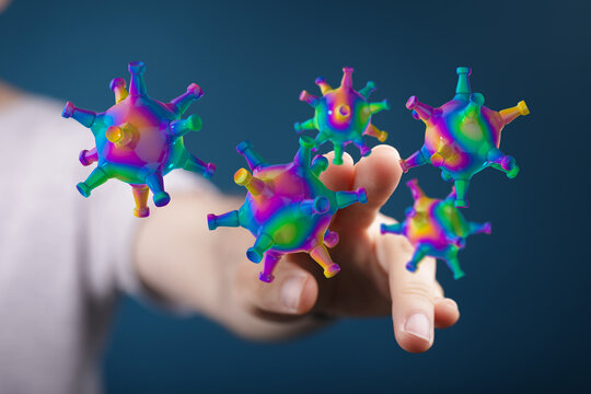 Conceptual image of hand interacting with abstract viruses, symbolizing disease, science, and healthcare. Perf