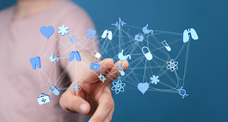 Person interacting with a digital medical network of healthcare symbols representing medical innovations and t