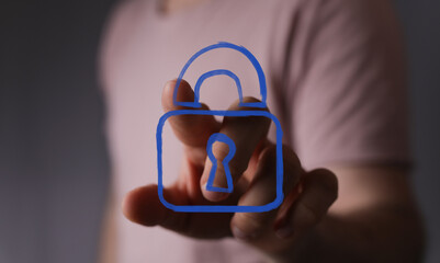 Concept of digital security and data protection. A hand interacts with a virtual padlock icon, symbolizing online privacy and safe connections.