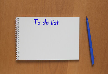 Open notebook with inscription: To do list and marker on table