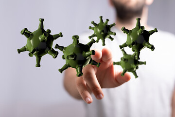 Concept of coronavirus or other infection spreading. Hand interacting with 3D rendered virus particles represe