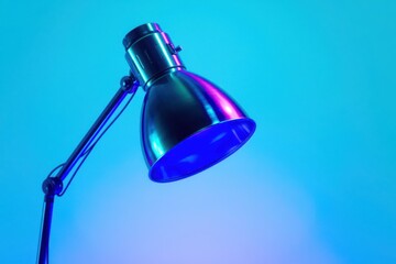 A lamp with a blue light shining on a blue background