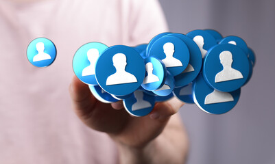 A hand holding floating icons, showcasing networking, teamwork, and online connection. Represents the concept of community and social media inte