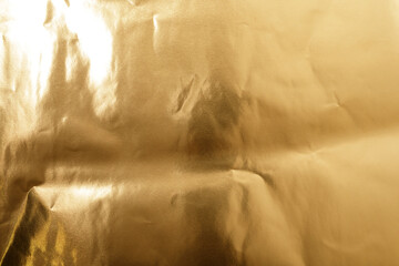 Elegant gold foil texture with wrinkles and light. Perfect for luxury backgrounds and design assets