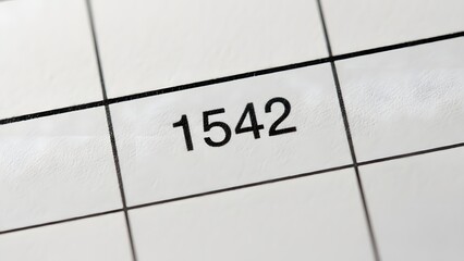 A close-up view of the number 1542 prominently displayed within a structured grid on a document, symbolizing precise data management, financial tracking, and organized record-keeping