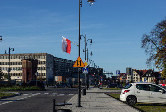 Polish Flag on City Street with Urban Architecture In Ustka