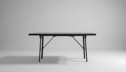 Modern black folding table in minimalist gray studio setting