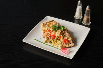 Plate of Italian  risotto on black wooden table