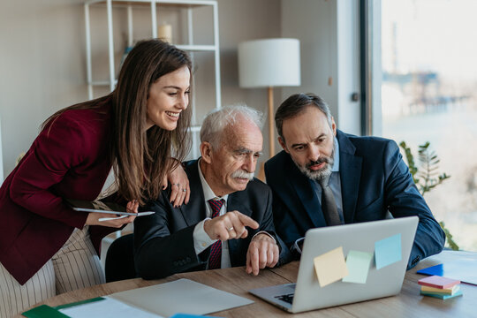 Multi-Generational Business Team Smiling Together in Modern Office &ndash; Family Business Atmosphere
