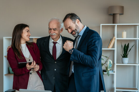 Senior Businessman with Son and Daughter in Modern Office &ndash; Family Business Transition