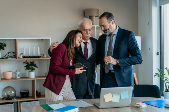 Senior Businessman with Son and Daughter in Modern Office &ndash; Family Business Transition