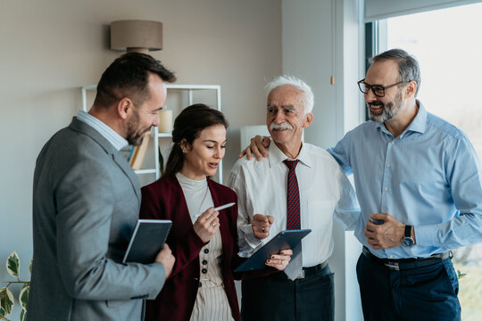 Multi-Generational Family Business Team Working Together in Modern Office &ndash; Warm Atmosphere