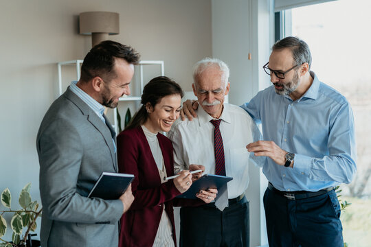 Multi-Generational Family Business Team Working Together in Modern Office &ndash; Warm Atmosphere