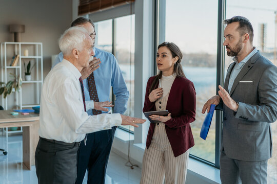 Multi-Generational Business Team Discussing Problem in Modern Office &ndash; Business Conflict