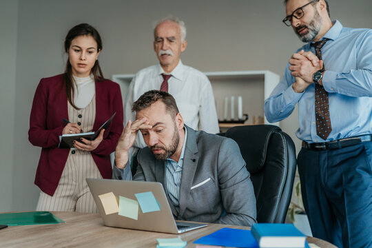 Multi-Generational Business Team Concerned in Modern Office &ndash; Business Problem Concept