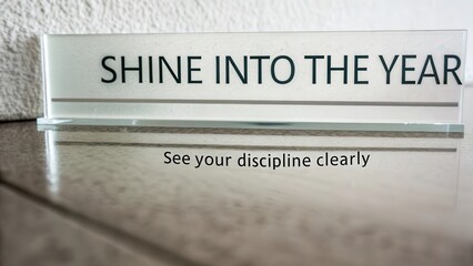 Glass surface reflects shine into the year message