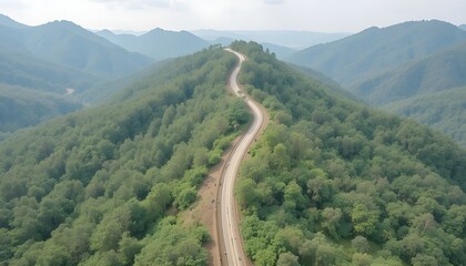 Aerial view of road in the middle of forest.Road curve construction up to mountain.Healthy environment concept and rainforest ecosystem.     




