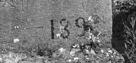 Ancient Stone Inscription Detail Closeup Monochrome. Weathered Carved Surface Texture Black White