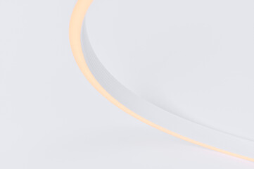 Flexible warm white led tape glowing on white background.