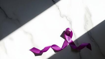 A flowing purple awareness ribbon lays elegantly on a white marble surface, dramatically illuminated by a sharp beam of light and shadow