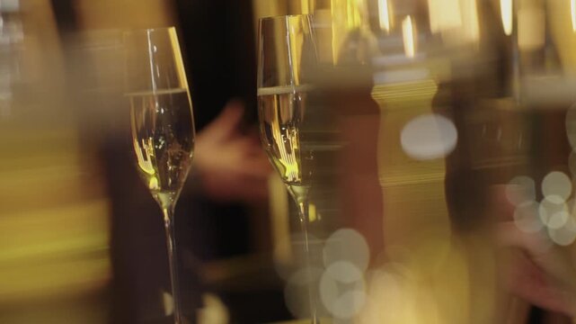 A glass of sparkling wine. A beautiful shade of champagne. Festive mood, smiles, and fun. A beautiful background and close-up of a glass of sparkling wine with fizzing bubbles.