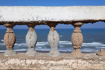 Spalling damage in reinforced concrete in seaside humid salty air conditions. Atlantic Coast and Pacific Coast problem: rusty rebar concrete damage.