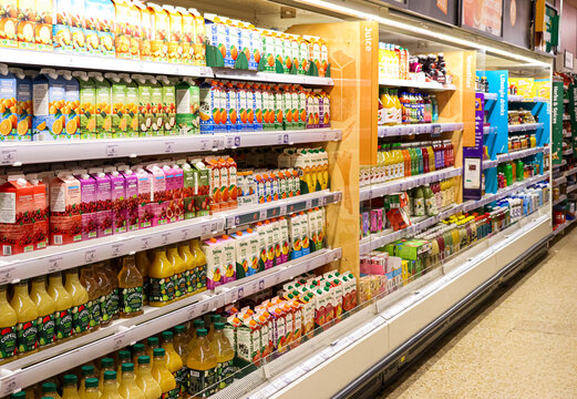 Apsley, England, UK December 12, 2025: Sainsbury's supermarket juice aisle with various brands and flavors of drinks