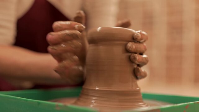 A potter makes a new clay vessel from clay. Pottery. The craft of throwing clay on a potter's wheel.