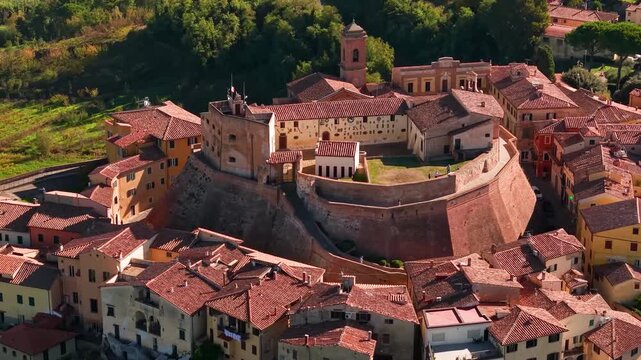 Aerial 4K close-up of Castello dei Vicari in Lari on 70mm lens. Detailed view of the medieval castle courtyard, ancient stone walls and historic fortress architecture, Tuscany, Italy.