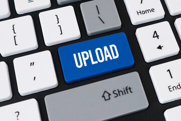 Upload button on computer keyboard. Concept of data sharing, cloud storage and digital content submission.