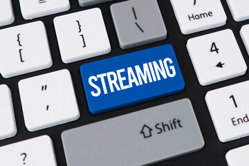 Streaming button on computer keyboard. Concept of online media, digital entertainment and video services.