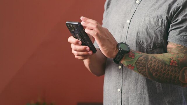 Modern Man's Hands Actively Engaging with a Smartphone, Showcasing Digital Connectivity and Daily Technology Use