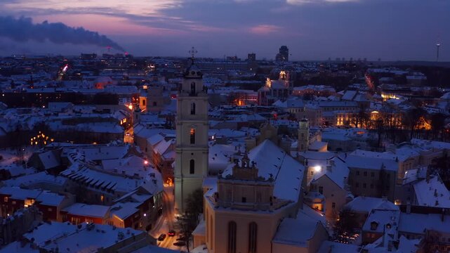 Vilnius, Lithuania &mdash; January 13, 2026. Late evening aerial view of downtown Vilnius, showcasing illuminated streets and St. John&rsquo;s Church.