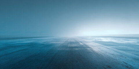 Empty ice track stretching into a foggy blue horizon