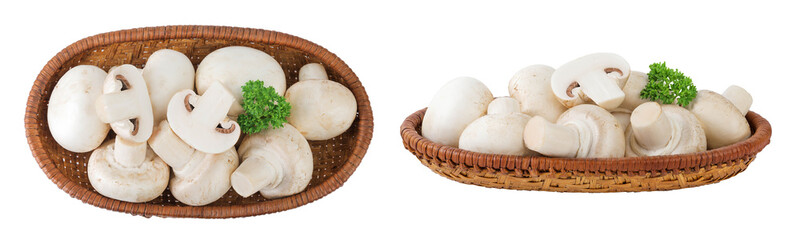 Fresh mushroom champignon in a wicker basket isolated on white background. Top view. Flat lay.