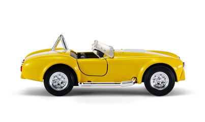 Miniature yellow toy racing car on white background