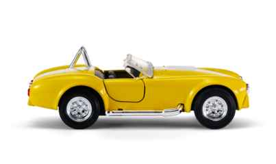 Miniature yellow toy racing car on white background