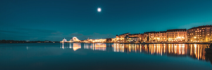 Obraz premium Helsinki, Finland. View Of Police Harbor Merikasarmin Laituri And Laivastokatu Street In Evening Night Illuminations